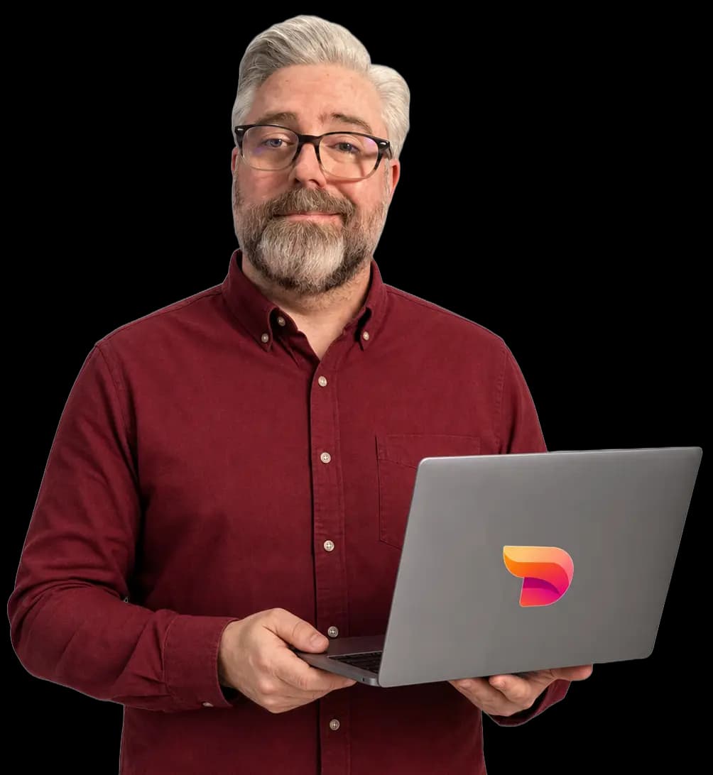 Jeremy Kenerson of DeskTeam360 holding a laptop, ready to support your team
