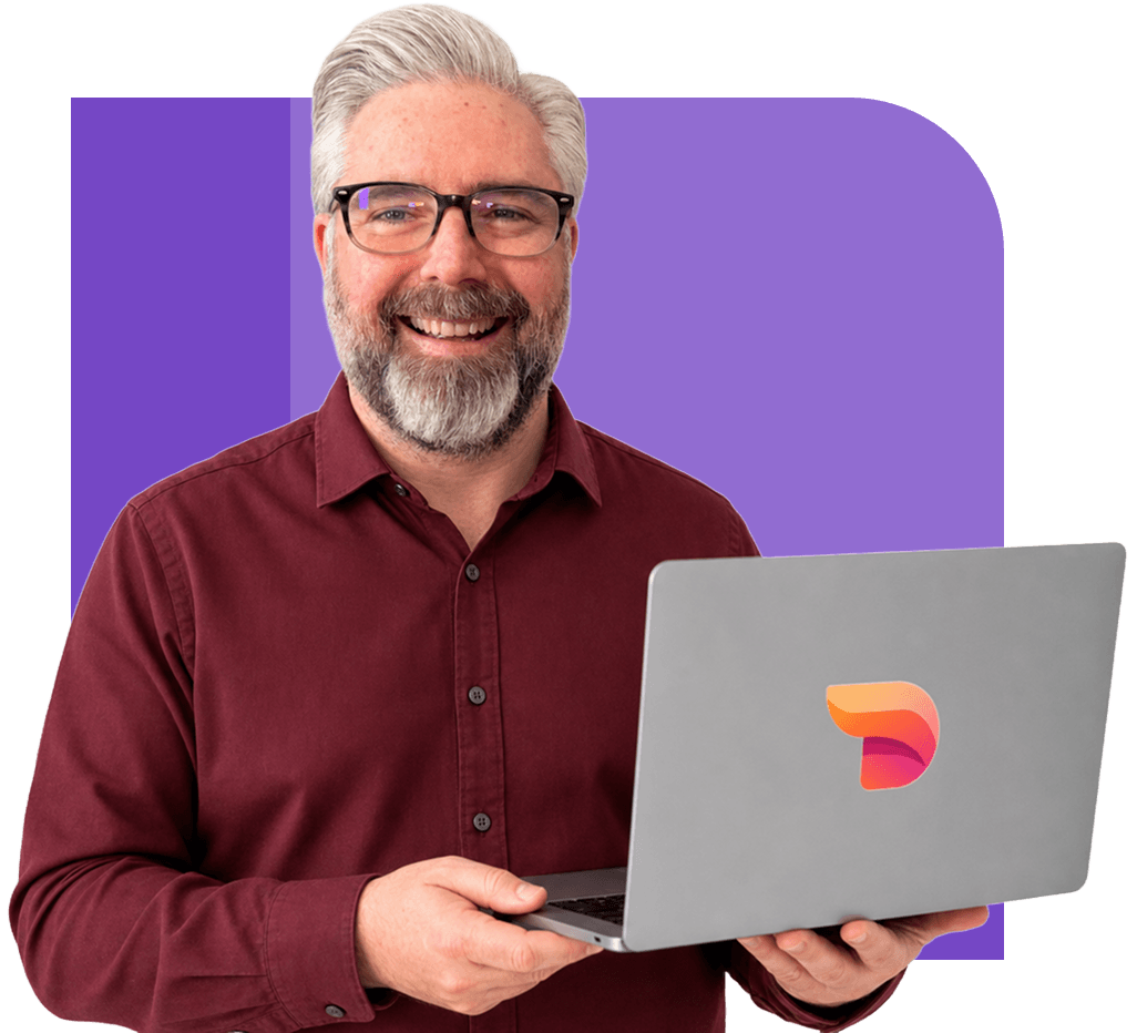 Jeremy Kenerson of DeskTeam360 giving a thumbs up while holding a laptop