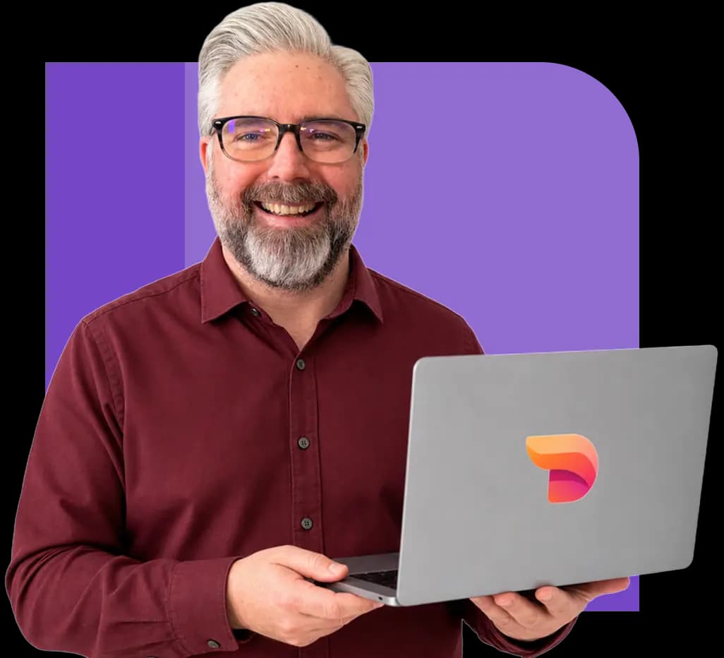 Jeremy Kenerson of DeskTeam360 giving a thumbs up while holding a laptop